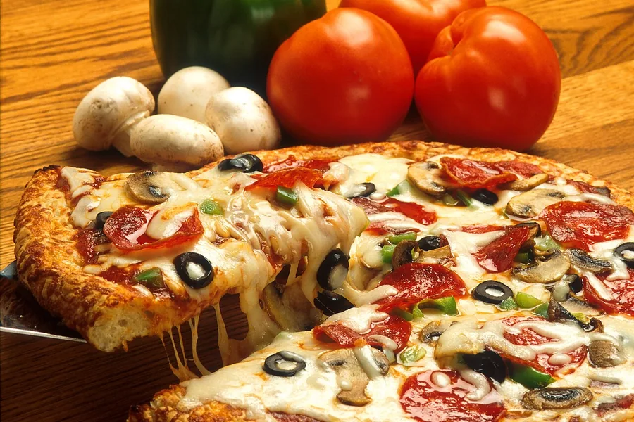 Supreme pizza with meat and vegetables — representative food photograph
