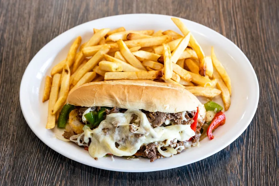 Philly cheesesteak with fries — representative food photograph